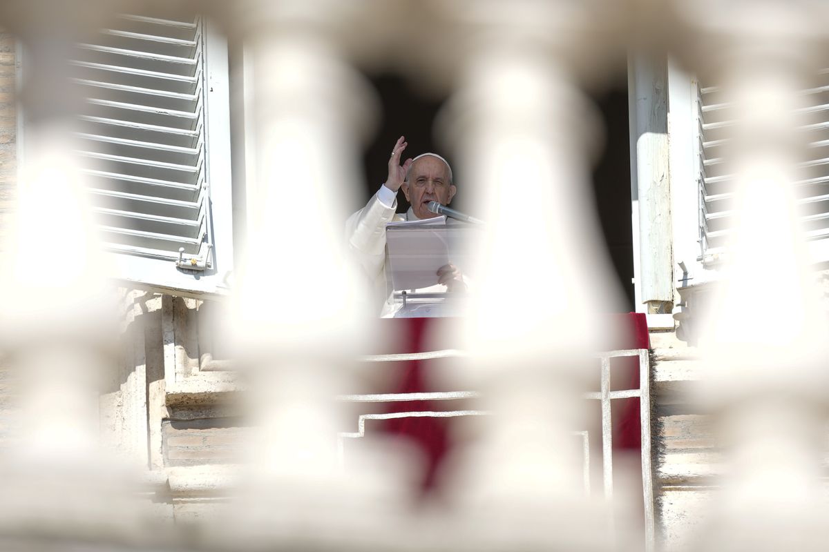 Pope Francis delivers his blessing as he recites the Angelus noon prayer from the window of his studio overlooking St.Peter