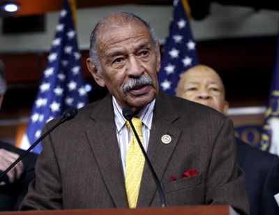 Rep. John Conyers, D-Mich., flanked by other top Democrats, speaks at a news conference on Capitol Hill in Washington on Feb. 14, 2017. (J. Scott Applewhite / Associated Press)