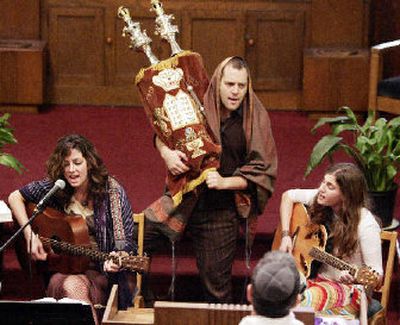
The Storahtelling troupe and its leader, Amichai Lau-Levie, center, take part in a service last Saturday in New York. The troupe blends modern performance with traditional Jewish ritual. 
 (Associated Press / The Spokesman-Review)
