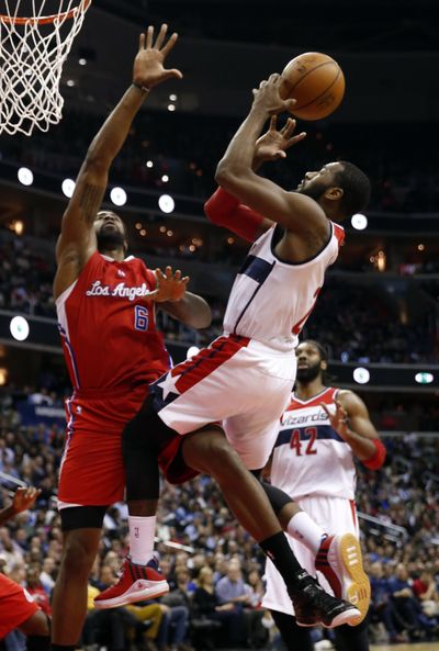 Wizards guard John Wall shoots over Clippers center DeAndre Jordan in 104-96 win. Wall had 10 points and 11 assists. (Associated Press)