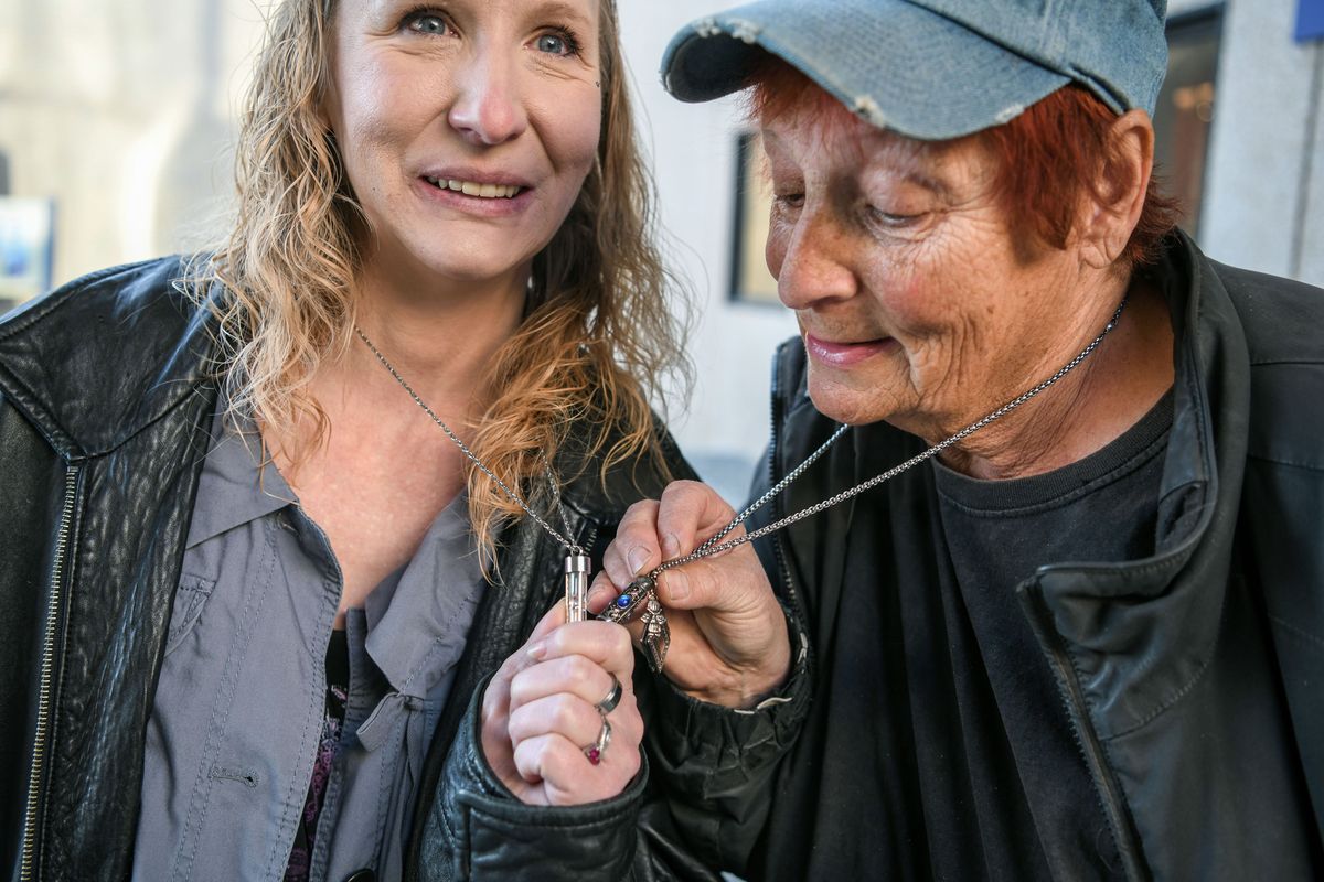 Koleen Sorenson, left, the longtime girlfriend of James Peterson, and Shirley DePew, Peterson’s mother, pause for a moment to touch urn necklaces containing his ashes after the sentencing of Robert Tolliver on Wednesday at the Spokane County Courthouse. Tolliver was sentenced on a robbery charge after pleading down from first-degree murder in exchange for his testimony against co-defendant Pierre Rhodes in the beating death of Peterson. Rhodes was acquitted on the murder charge last month.  (DAN PELLE/THE SPOKESMAN-REVIEW)