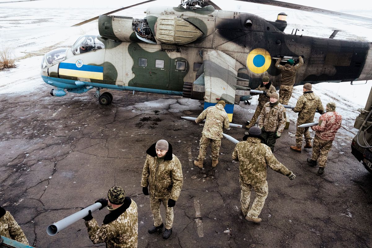 Members of the ground crew from the 18th Sikorsky Brigade re-supply a combat helicopter with rockets prior to a mission in Eastern Ukraine in February. Far from being knocked out in the first days of the war, Ukraine’s helicopter brigades are still operational, a critical element of its defense.  (DANIEL BEREHULAK)