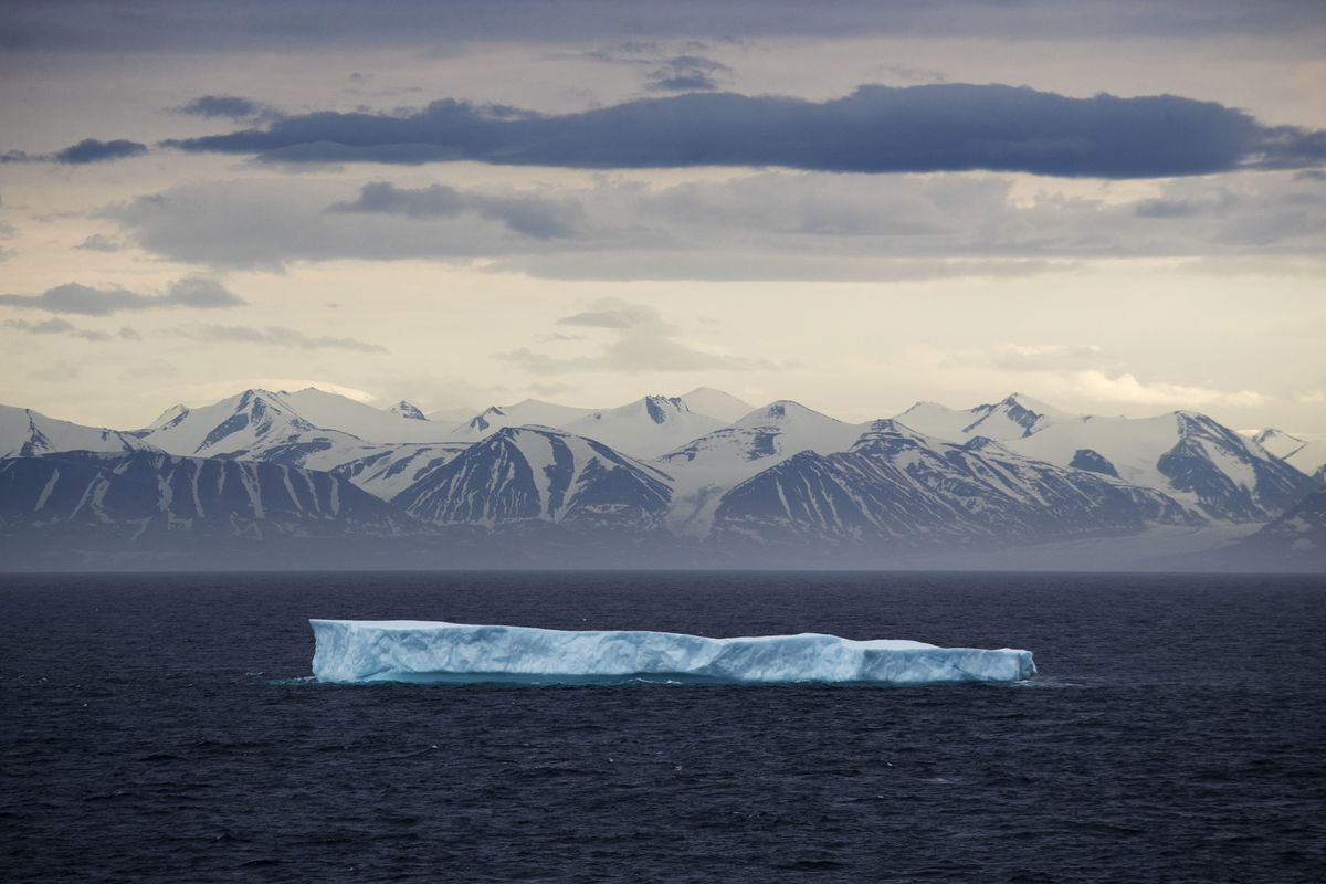 FILE - In this July 24, 2017 file photo, an iceberg floats past Bylot Island in the Canadian Arctic Archipelago. The National Oceanic and Atmospheric Administration’s annual Arctic Report Card, released on Tuesday, Dec. 8, 2020, shows how warming temperatures in the Arctic are transforming the region