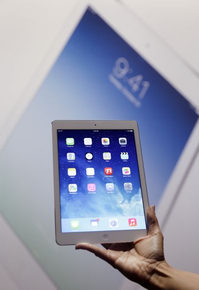 An Apple employee shows off the new iPad Air on Tuesday in San Francisco. (Associated Press)