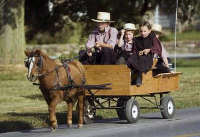 
Amish children ride to a luncheon at a home along Mine Road on Monday in Nickel Mines, Pa., as families  mark the one-year anniversary of a massacre at a one-room schoolhouse nearby. Daily Local News
 (Tom Kelly IV Daily Local News / The Spokesman-Review)