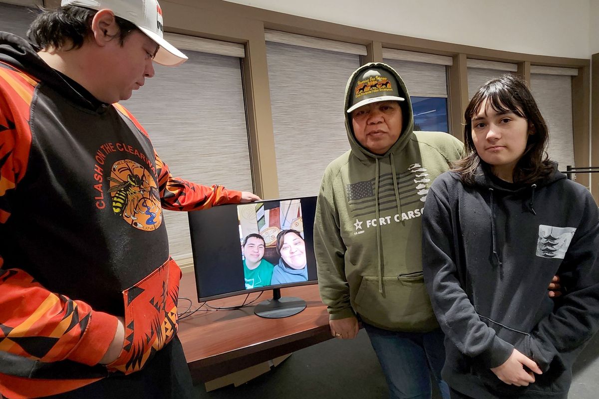 Coby Dick, Janice Dick and Natalie Vieira stand around a photo of Laura Dick and Anthony Vieira. Laura and Anthony were killed on Thursday night, a former boyfriend of Laura’s reporting to police that he stabbed them, per court records.  (Cannon Barnett / The Spokesman-Review)