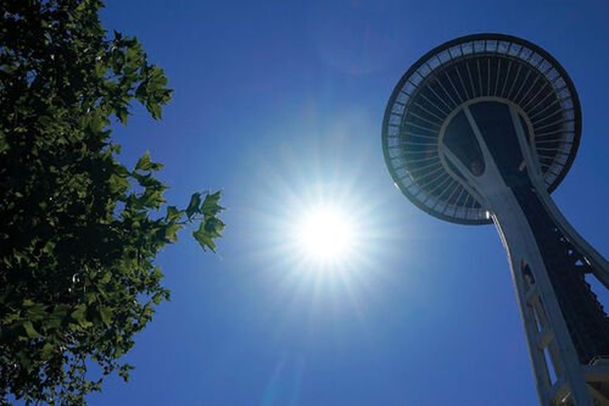 The sun shines near the Space Needle in Seattle. The monument was built 60 years for the World