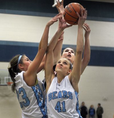 Central Valley’s Brooke Gallaway and Madison Hovren (41) block out Lewis and Clark to control a rebound. (Christopher Anderson)