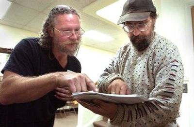 
Steven Aver, right, examines court papers with his friend Jerry Goforth in the Bonner County Courthouse Thursday. Aver, an amateur lawyer, was ordered out of the courthouse because of his smell. Now he has used a little-known state law from 1864 to bring charges against a district judge, bailiffs and other courthouse employees.
 (Jesse Tinsley / The Spokesman-Review)