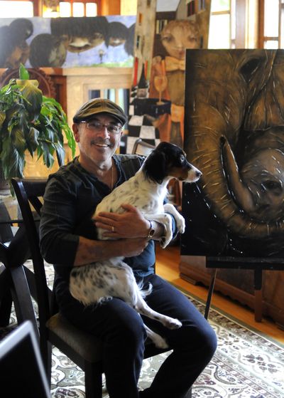 Tom Norton poses for a photo with his dog Sophie in his home on the South Hill on Wednesday. (Liz Kishimoto)