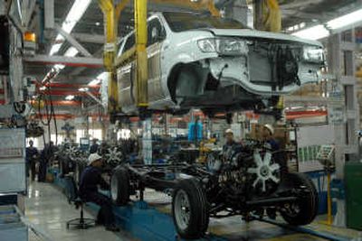 
Employees work at the manufacturing plant of General Motors in Halol, India. Growing international markers lifted GM to its third straight quarterly gain. Associated Press
 (Associated Press / The Spokesman-Review)