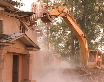 Rick Bishop with Kootenai County Solid Waste Department levels a wall on the old Kootenai County Jail and Sheriff's office. The unused structure is being removed to make room for new county buildings in the future. (Craig Buck/SR file photo)