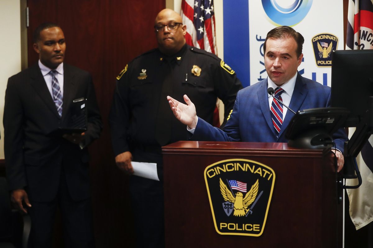Cincinnati Mayor John Cranley speaks alongside police chief Eliot Isaac, center, and assistant fire chief Roy Winston, left, during a news conference at police headquarters regarding a fatal shooting at the Cameo club, Sunday, in Cincinnati. (John Minchillo / Associated Press)