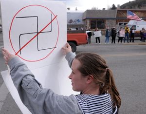 Carlene Herburger, of Mount Vernon, Ore., holds a sign as she joins a group of local residents to protest the planned purchase of a  building to house the future Aryan Nations headquarters in John Day, Ore. on Friday, Feb. 26, 2010. (Pete Erickson / The Bulletin)