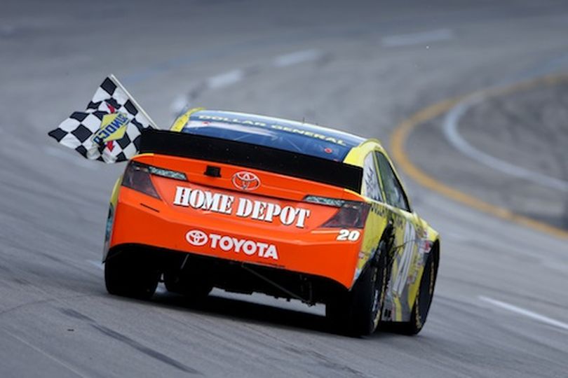 Matt Kenseth, driver of the #20 Dollar General Toyota, celebrates with the checkered flag after winning the NASCAR Sprint Cup Series Quaker State 400 at Kentucky Speedway on June 30, 2013 in Sparta, Kentucky. (Photo by Todd Warshaw/Getty Images) (Todd Warshaw / Getty Images North America)