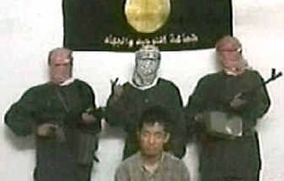 
A man identified as Kim Soong Il of South Korea sits in front of his captors in this image taken from a video. 
 (Associated Press / The Spokesman-Review)