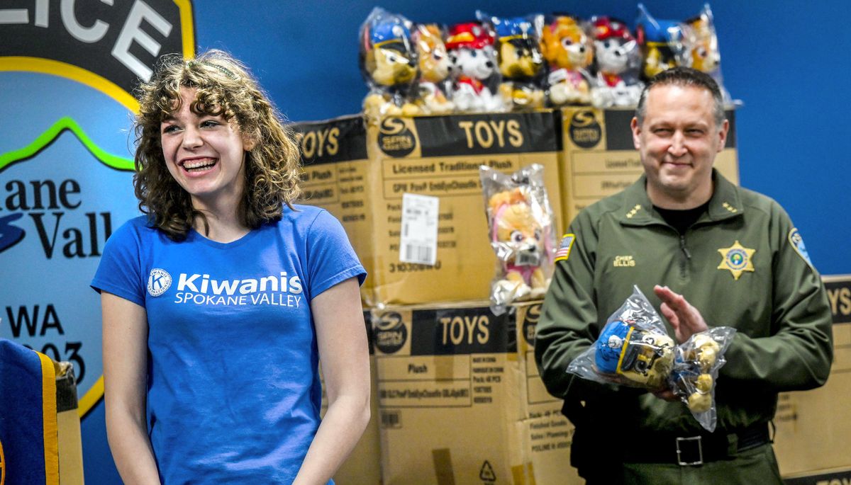 Thirteen-year-old Sabriel Wick is cheered on Friday by Spokane Valley Police Chief Dave Ellis as she talks about spearheading a $10,000 fundraising effort for the Spokane Valley Kiwanis Club to purchase stuffed animals for the Spokane Valley police and firefighters to give out to children they meet. (Kathy Plonka/The Spokesman-Review)