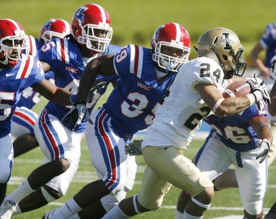 Louisiana Tech defensive back Justin Goodman, left, linebacker Jay Dudley, second from left, running back Roosevelt Falls (39) and running back Myke Compton (26) try to stop Idaho wide receiver Justin Veltung (24) in Saturday's game.  (Terrance Armstard / The News-star)