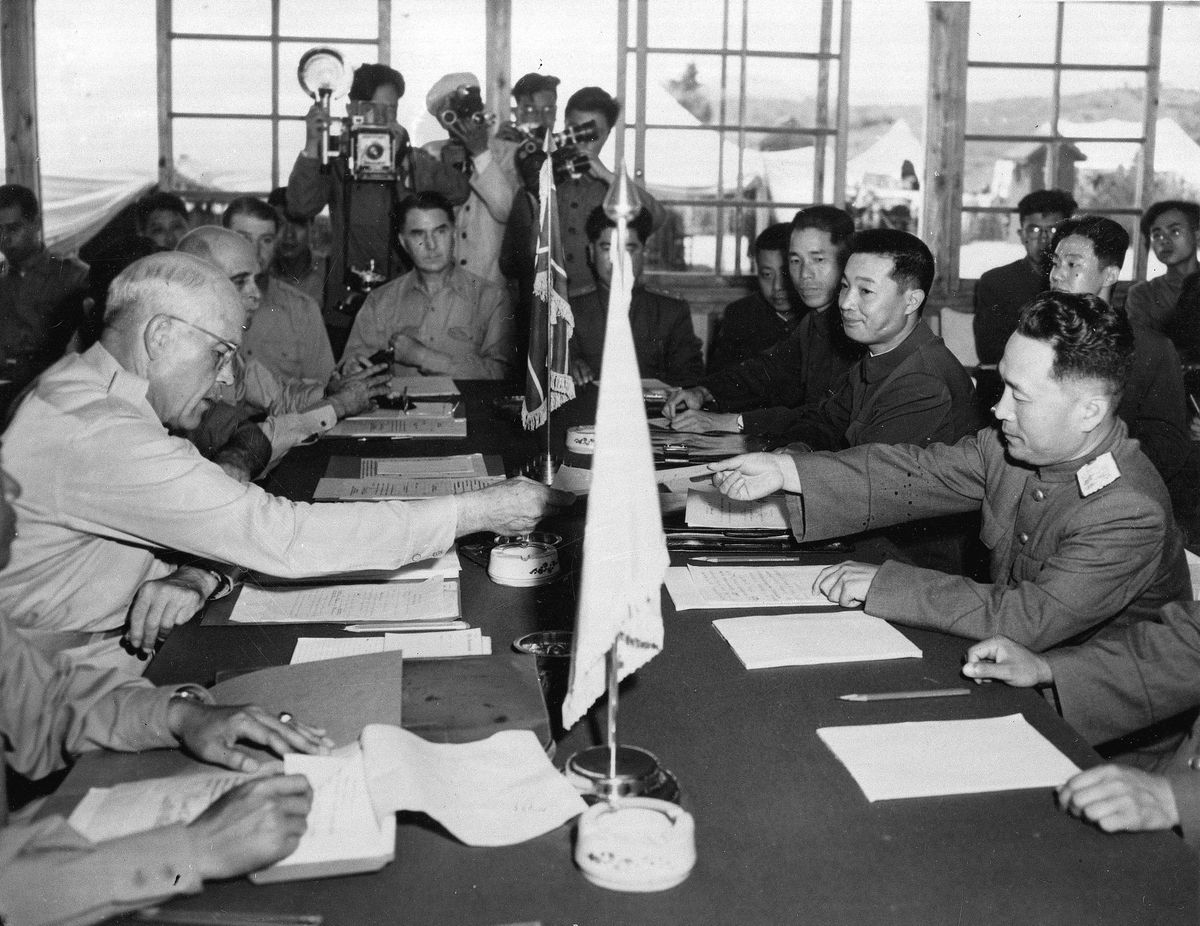 Maj. Gen. Blackshear M. Bryan, left, exchanges credentials with Communist Lt. Gen. Lee Sang Cho at the opening session of the Military Armistice Commission on July 28, 1953, at the Panmunjom Conference House.  (AP)