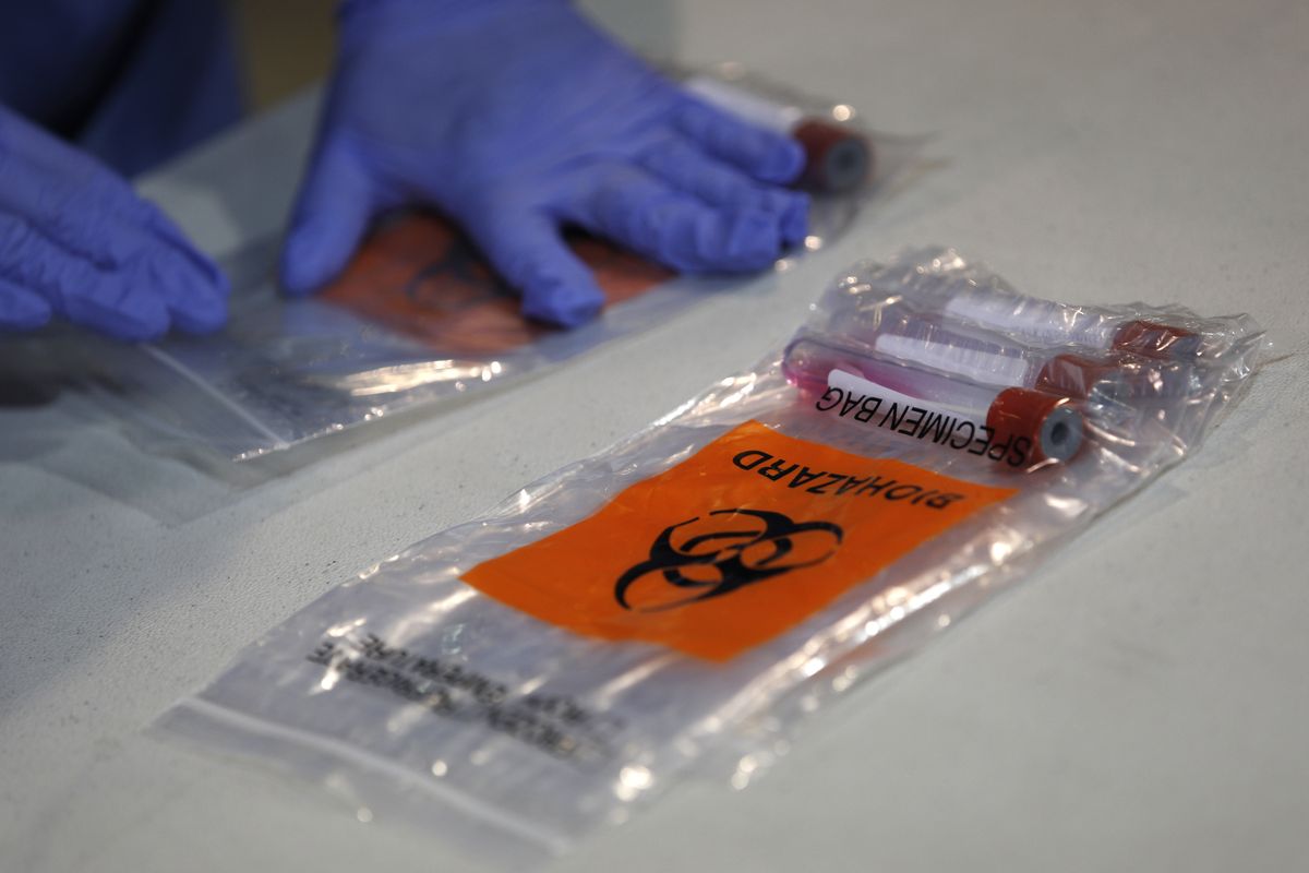 Nasal swab coronavirus testing kits sit on a table during a tour of a new temporary coronavirus testing site Monday, Aug. 3, 2020, in Las Vegas.  (John Locher)