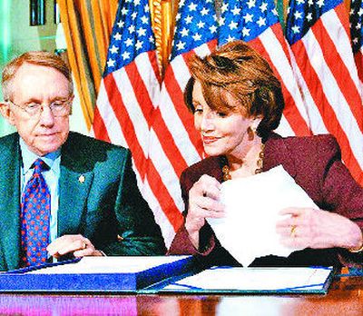 
Senate  Majority Leader Sen. Harry Reid, of Nevada, and House Speaker Nancy Pelosi, of California, look over legislation to fund the Iraq war Tuesday. Bush and Democrats are seeking a compromise on war funding after Bush vetoed a spending bill Tuesday.  Story on A4. 
 (Associated Press / The Spokesman-Review)