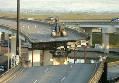 
Construction crews  work on a damaged portion of Interstate 580 near Oakland, Calif., on Tuesday. 
 (Associated Press / The Spokesman-Review)