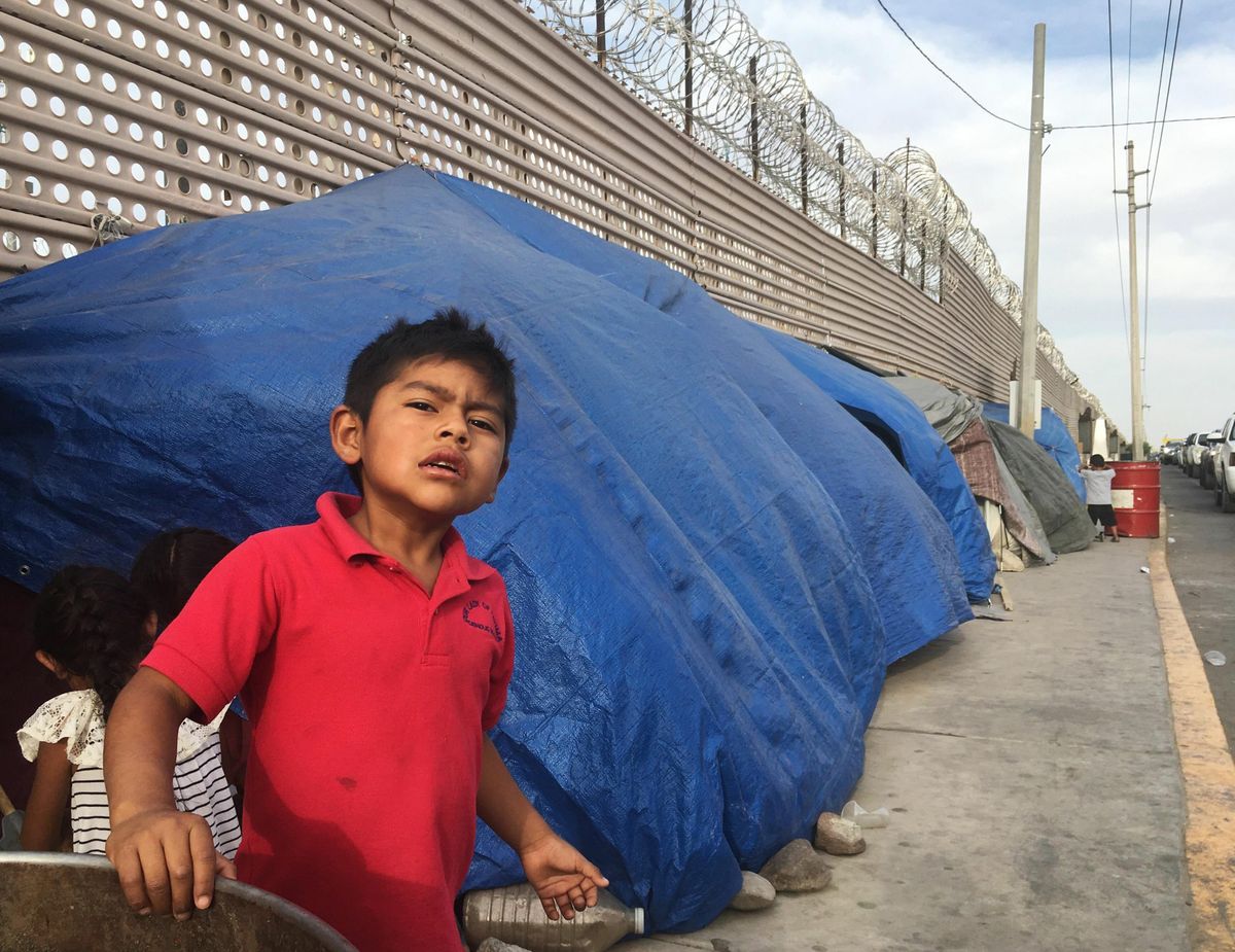 On  Sunday, May 5, 2019, migrant kids play near tents as they wait to cross the border in San Luis Rio Colorado, Mexico, and Arizona. The tent slots are for families about to be called, allowing them to be ready on a moment’s notice. (Elliot Spagat / Associated Press)