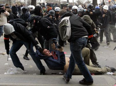 
Plainclothes police officers drag away a young man after a demonstration against the French government's labor laws. 
 (Associated Press / The Spokesman-Review)