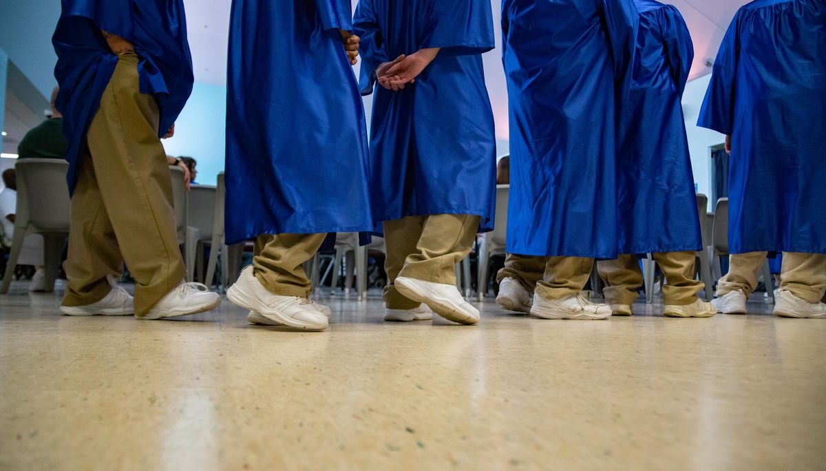 Inmates line up to receive diplomas for GED, vocational and associate degree programs during a commencement ceremony at Airway Heights Corrections Center on Thursday, April 25, 2019. (Libby Kamrowski / The Spokesman-Review)
