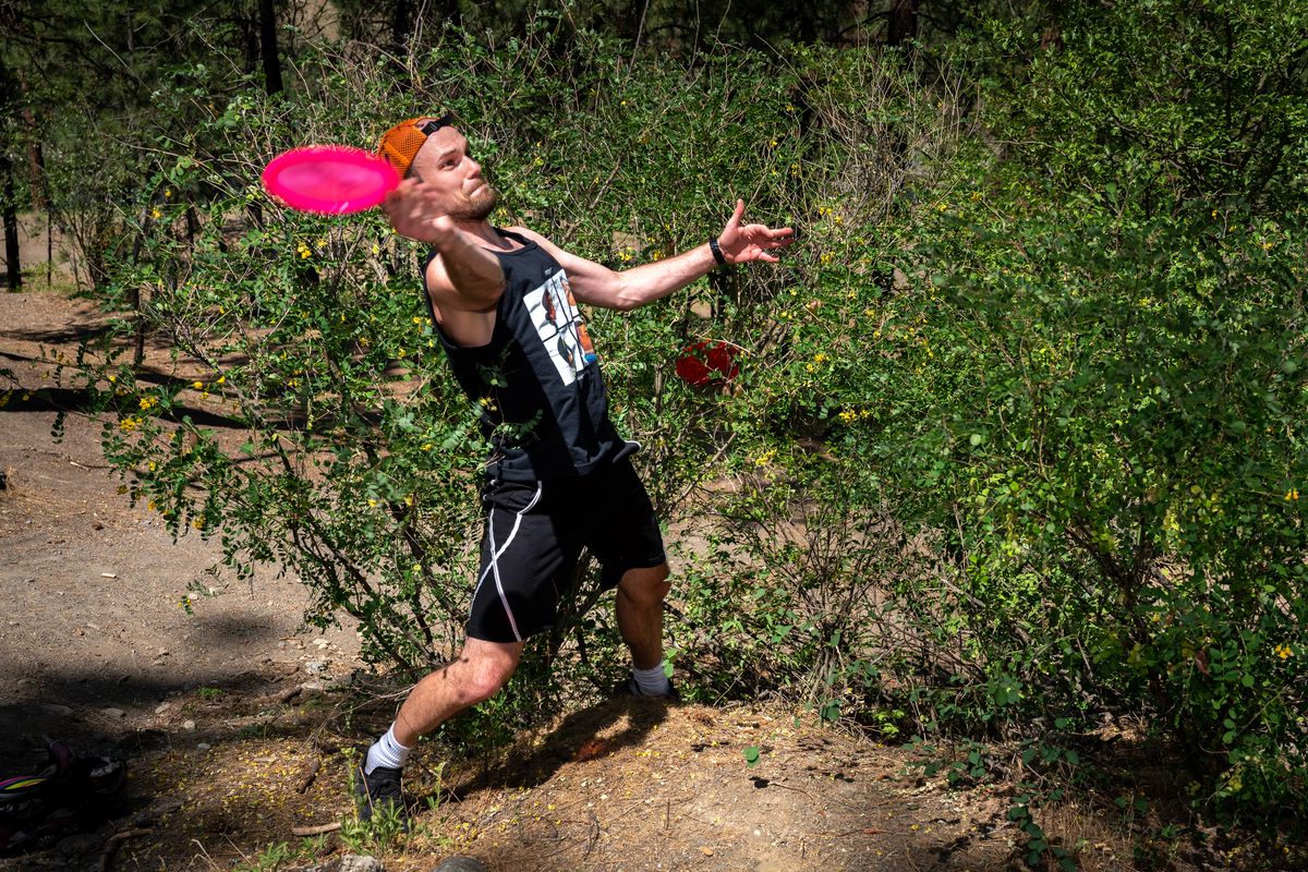 Kiefer Larsen tees off on the fifth hole Tuesday at the city-owned Downriver Disc Golf Course at Riverside State Park. The course is getting a renovation because of a city stormwater filtration project that will add stormwater collection ponds on the course.  (COLIN MULVANY/THE SPOKESMAN-REVIEW)