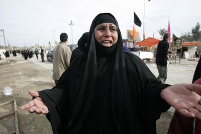 An Iraqi woman cries at the site of a suicide bombing near Musayyib, Iraq, on  Friday. The attack on a tent filled with women and children killed 40 people and wounded about 80.  (Associated Press / The Spokesman-Review)