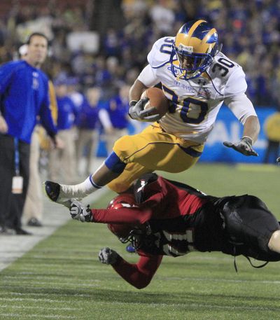 Delaware running back Andrew Pierce (30) jumps over Eastern Washington cornerback Jesse Hoffman (21) during the first half of the FCS Championship football game, Friday, Jan. 7, 2011, in Frisco, Texas. (Lm Otero / Associated Press)