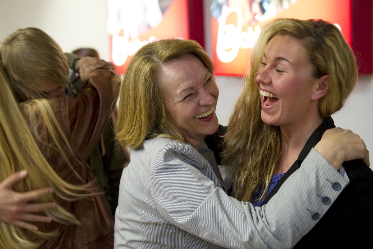 A passenger is embraced as  she  returns from  Spain, at Tegel airport in Berlin, on Tuesday.