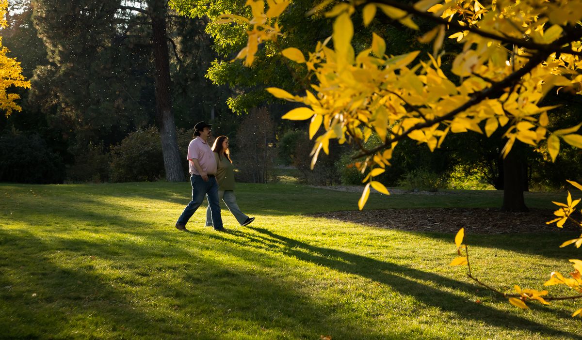 Hand in hand, Joshua and Erica Smith go for an evening stroll during golden hour on Oct. 5, 2020 at Finch Arboretum in Spokane, Wash. The 65 acres of the arboretum allow for easy social distancing and approxmiately 2000 types of trees and plants, as well as various man-made features such as small bridges and a gazebo.  (Libby Kamrowski/The Spokesman-Review)