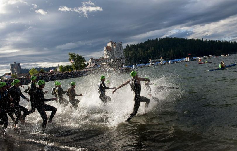 Competitors race into the water to begin the 2014 Coeur d'Alene Ironman. (Tyler Tjomsland / The Spokesman-Review)