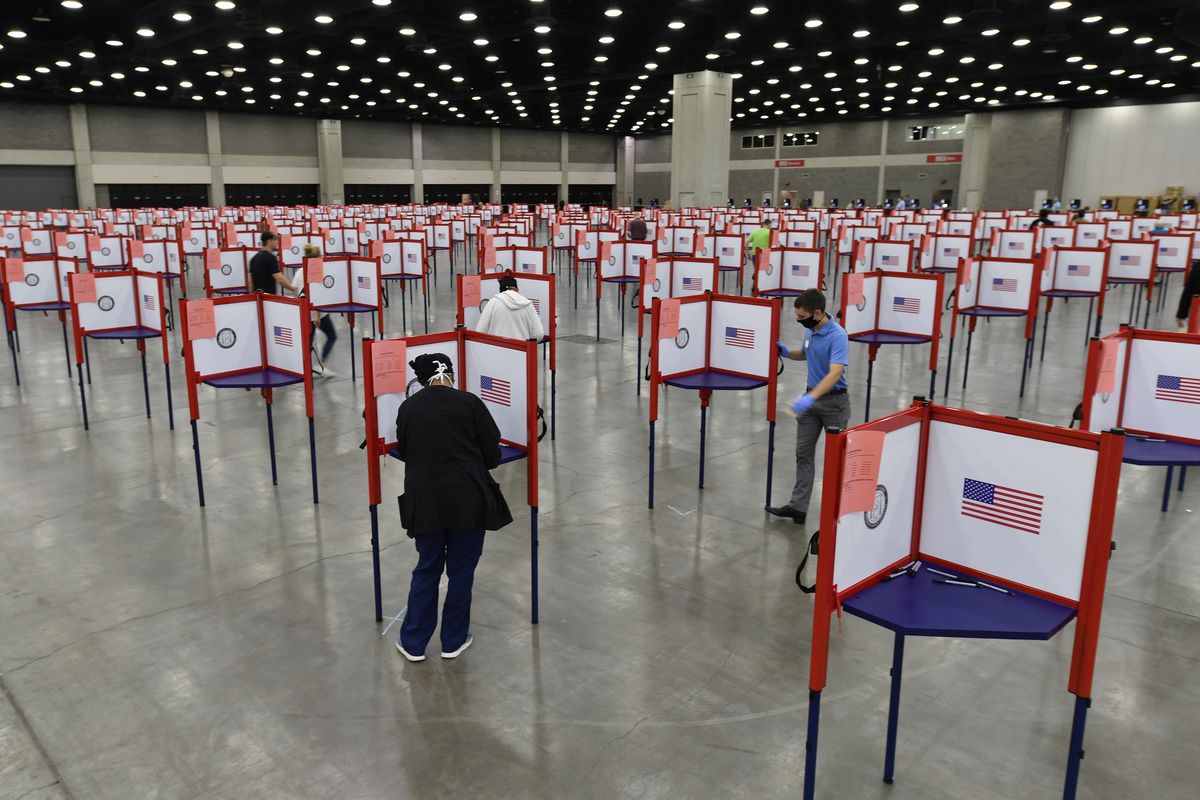 FILE - In this June 23, 2020, file photo voting stations are set up in the South Wing of the Kentucky Exposition Center for voters to cast their ballot in the Kentucky primary in Louisville, Ky. The November election is coming with a big price tag as America faces the coronavirus pandemic. The demand for mail-in ballots is surging, election workers are in need of training and polling booths might have to be outfitted with protective shields. (AP Photo/Timothy D. Easley, File)  (Timothy D. Easley)