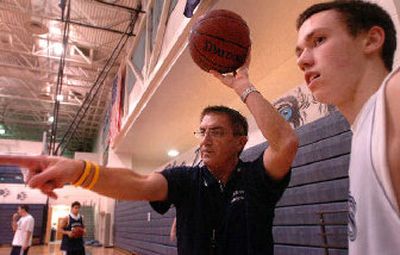 
New Lake City basketball coach Jim Thacker works with his team, including Jeff Marfice, right, during practice.
 (Jesse Tinsley / The Spokesman-Review)