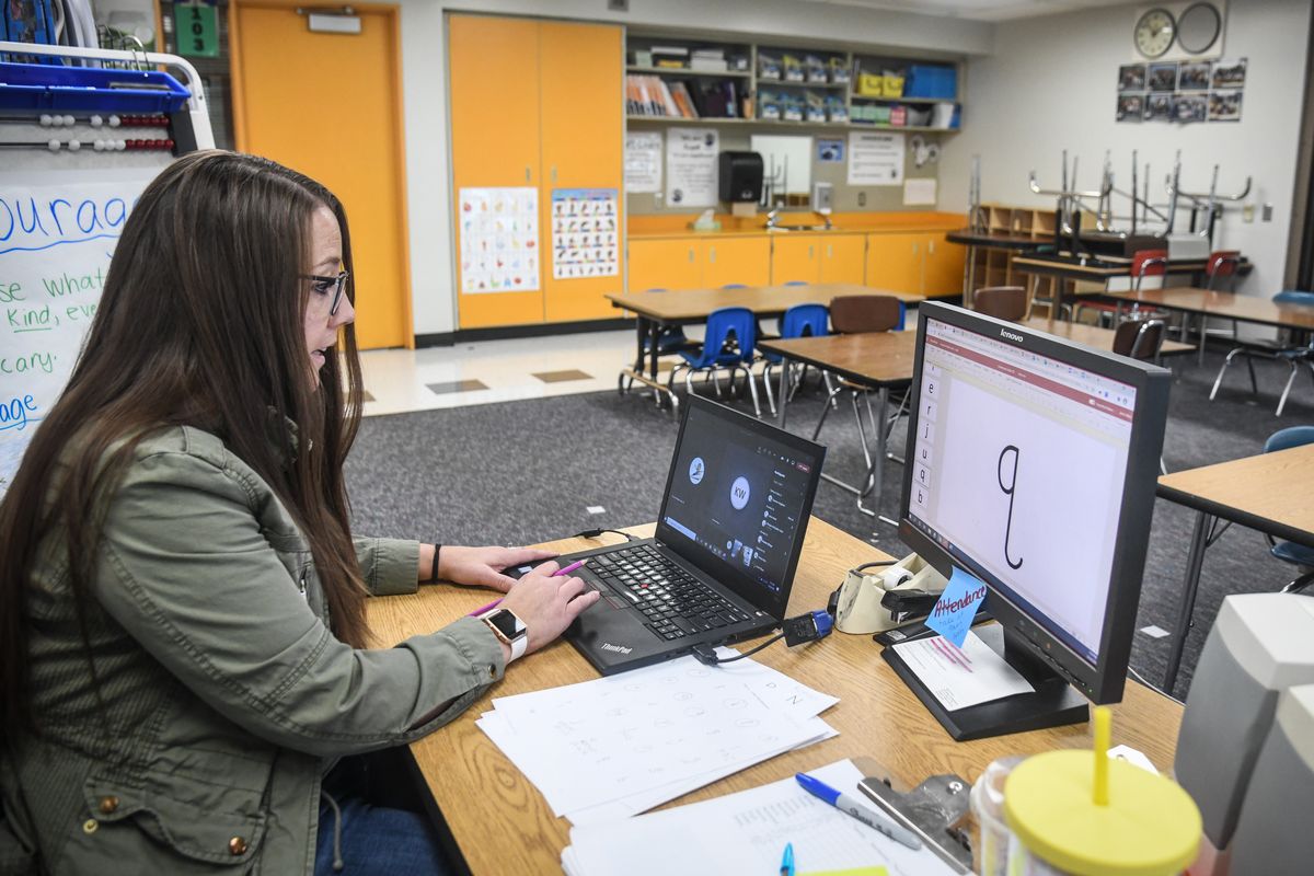 Regal Elementary School kindergarten teacher Jamie Ward works with a student from an empty classroom during a remote lesson on uppercase and lowercase letter identification Thursday afternoon in Spokane.  (DAN PELLE)