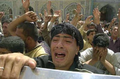 
Iraqis arrive at the holy shrine of Shiite Islam after clashes broke out between U.S. forces and Shiite militiamen in Najaf on Tuesday. The inner gate of the shrine, leading into the tomb of Imam Ali Ibn Abu Talib, was hit by a projectile. Iraqis arrive at the holy shrine of Shiite Islam after clashes broke out between U.S. forces and Shiite militiamen in Najaf on Tuesday. The inner gate of the shrine, leading into the tomb of Imam Ali Ibn Abu Talib, was hit by a projectile. 
 (Associated PressAssociated Press / The Spokesman-Review)