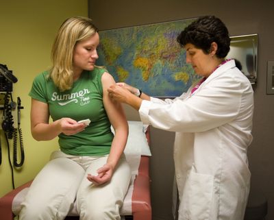 Courtney Banzer receives an HPV vaccine from Dana Varon at Harborview Women’s Research clinic in Seattle.