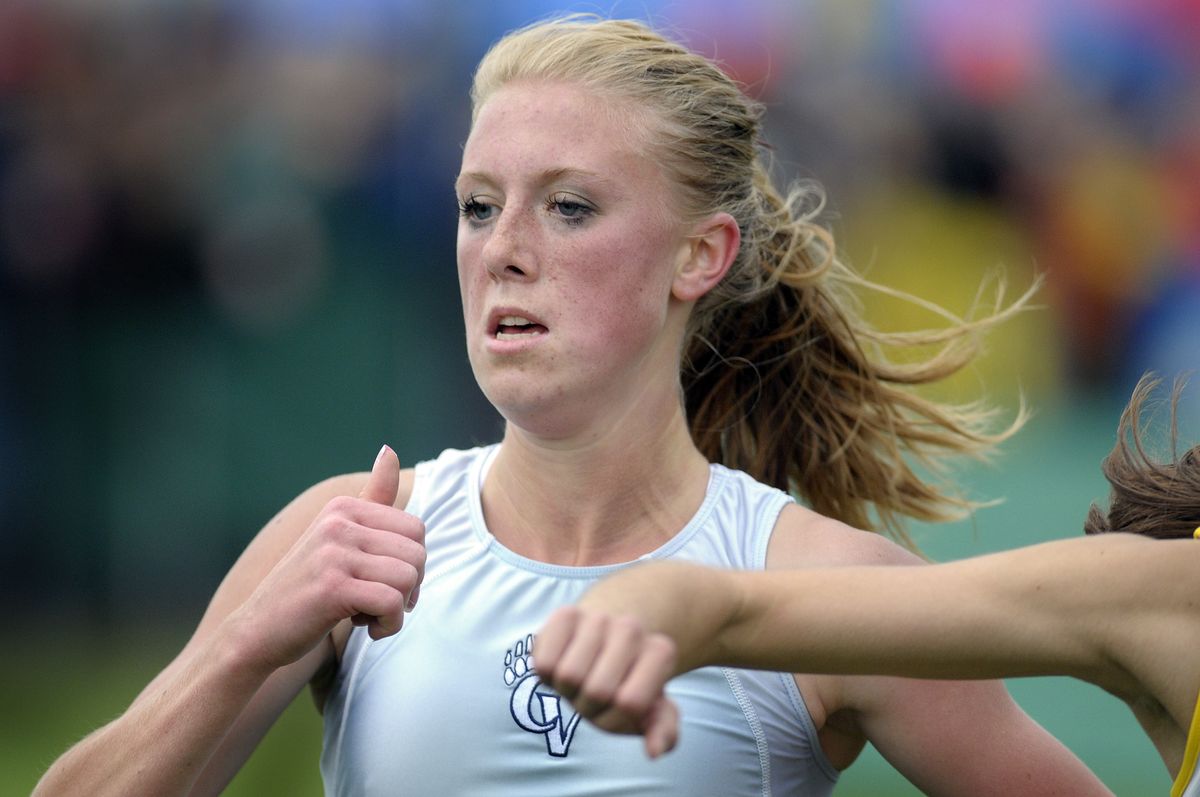 Eden Lake of Central Valley fights through an arm block at the finish line of the 4A Girls State Cross Country Championship at Sun Willows in Pasco  Nov. 8. (Christopher Anderson / The Spokesman-Review)