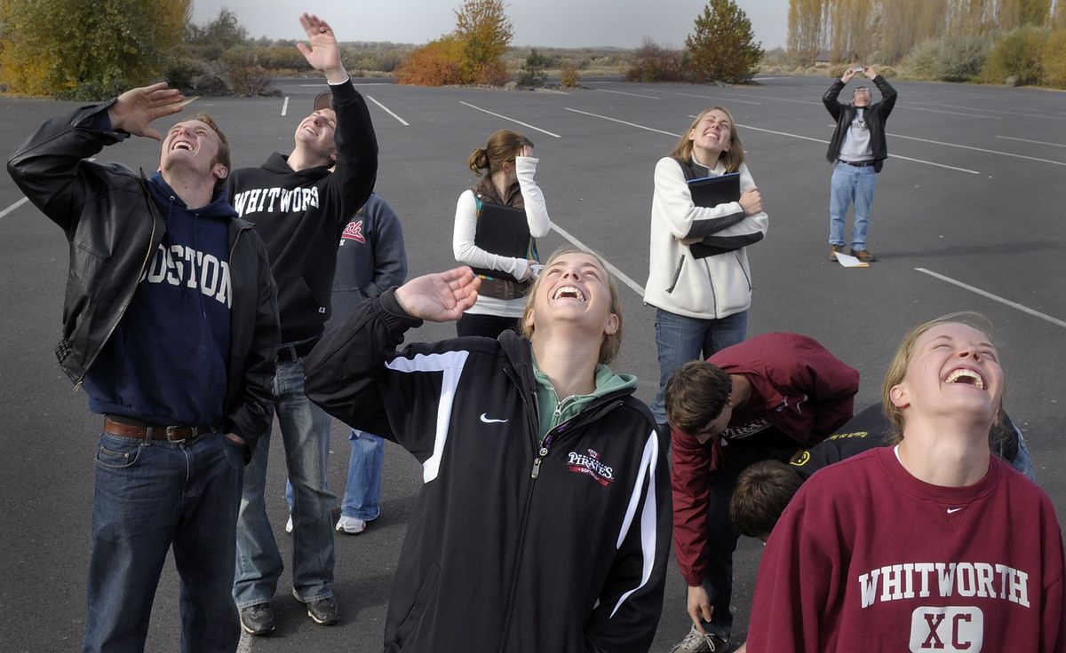 Whitworth physics students watch and wave as their instrumentation pods  float upward from Potholes State Park  on Thursday.  The helium-filled balloon took the pods to 98,000 feet before bursting and floating back to earth via parachute. The students lost contact just below 20,000 feet on the descent.  (CHRISTOPHER ANDERSON photos / The Spokesman-Review)