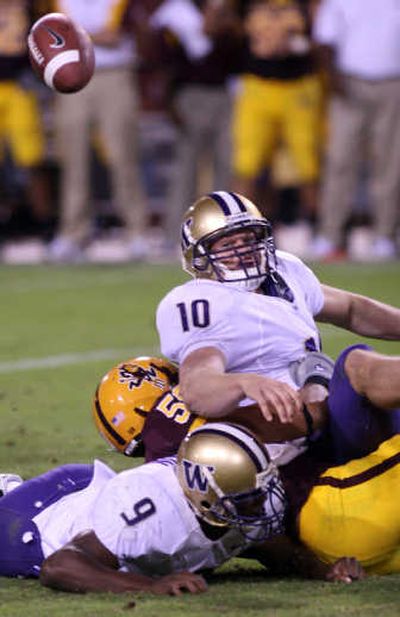 
Washington quarterback Jake Locker, top, fumbles the ball on a tackle by Arizona State's Dexter Davis during the third quarter Saturday. Associated Press
 (Associated Press / The Spokesman-Review)