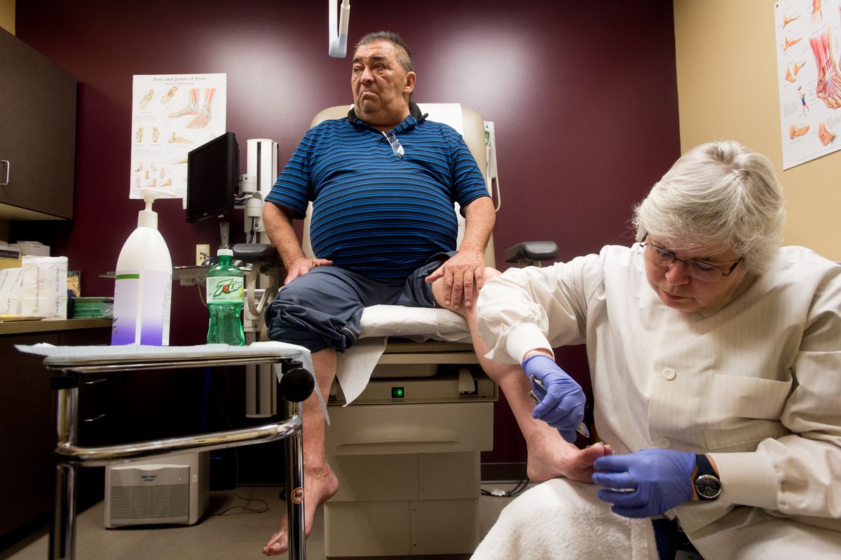 Perry Kitt has his feet examined by Judy Gordon an RN and certified diabetes educator on Tuesday, Feb. 3, 2015, at Benewah Medical Center in Plummer, Id. Maintaining feet is crucial for patients like Perry, Gordon said. "Preventing amputations is huge. (Tyler Tjomsland / Spokesman Review)
