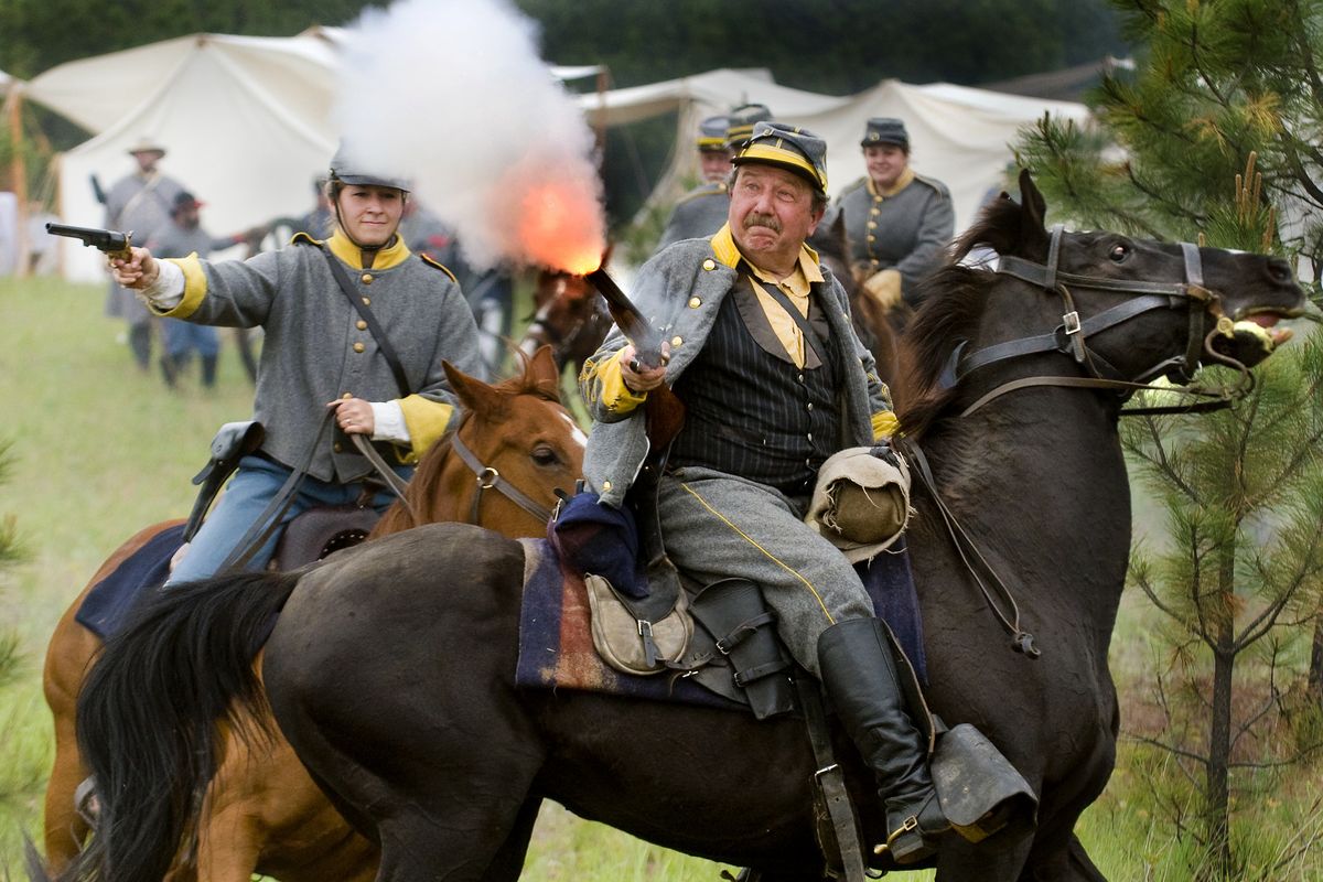 Capt. Bob Davisson with the 14th Virginia Cavalry Regiment of Re-enactors fires his weapon during a skirmish with Union soldiers during a re-enactment of the Civil War battle of Chickamauga on Saturday in Riverside State Park. (Colin Mulvany)