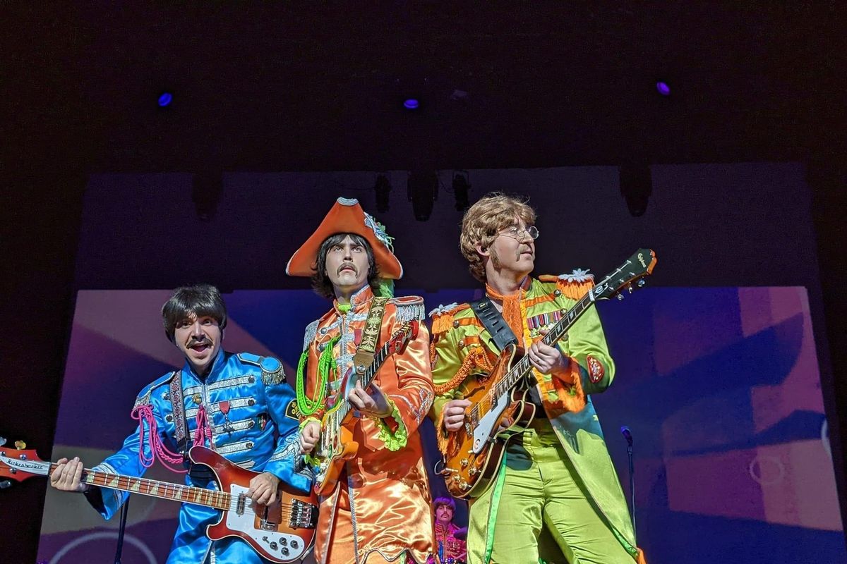 Robbie Berg, center, performs as George Harrison with the Fab Four.  (Donna Reedy)