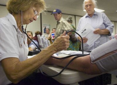 
Jackie Disotell takes a blood pressure reading Monday  during Spokane's Slavic Health Fair. About 20,000 to 25,000 Slavic immigrants live in Spokane County.  
 (CHRISTOPHER ANDERSON / The Spokesman-Review)