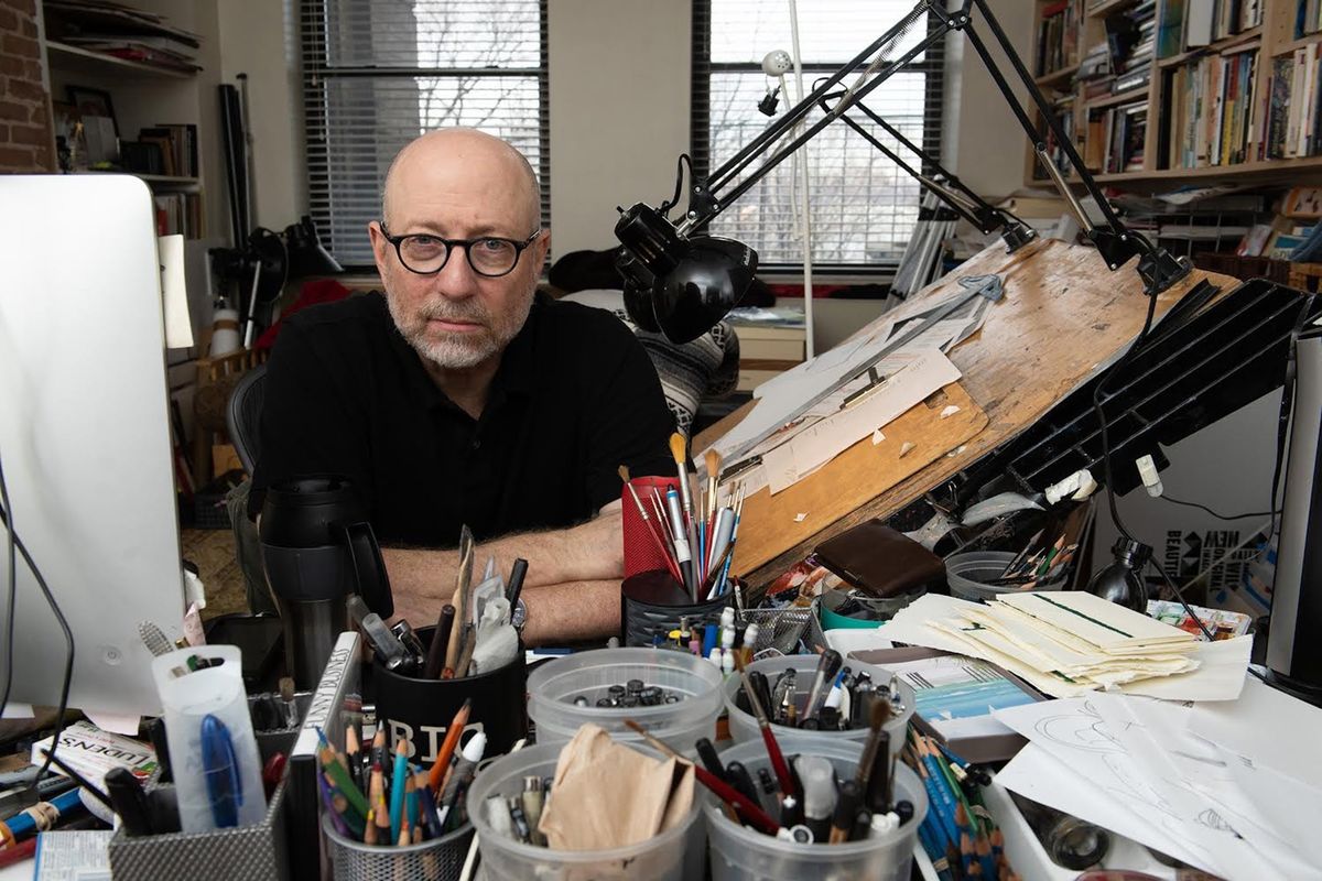 Chronicling the pandemic through art was “a day-to-day reaction,” said Steve Brodner, pictured in his New York studio. Nearly two years of illustrations are collected in his new book, “Living & Dying in America.”  (Leo Sorel)