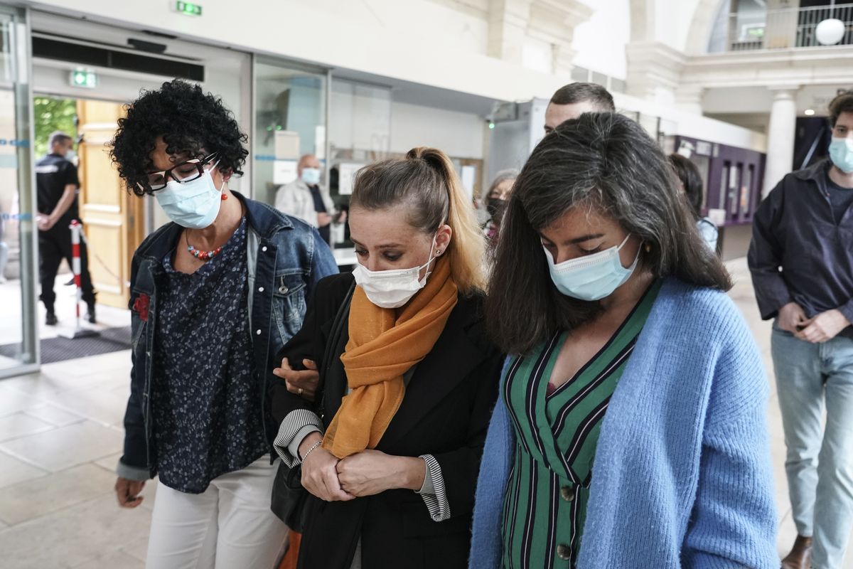 Valerie Bacot, center, arrives with relatives at the Chalon-sur-Saone courthouse, central France, Thursday, June 24, 2021. Valerie Bacot is on trial in France for killing her husband after decades of sexual, physical and psychological abuse starting when she was an adolescent, in a case that has drawn broad attention and support for Bacot amid a national reckoning with long-held taboos around domestic abuse. (Laurent Cipriani)