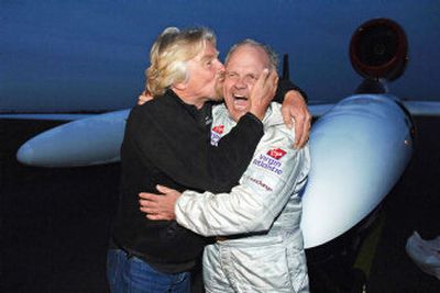 
Steve Fossett, right, is kissed by financial sponsor Richard Branson at Bournemouth, England, on Saturday after completing the longest nonstop flight in aviation history. 
 (Associated Press / The Spokesman-Review)